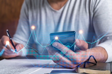 Multi exposure of man signing contract with phone and financial chart hologram. Concept of market...
