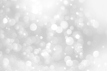 Plakat White glitter vintage lights background. White bokeh on black background.