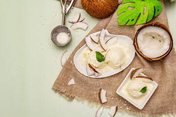 Lactose free coconut ice cream. Special spoon, halves of fruit, flakes