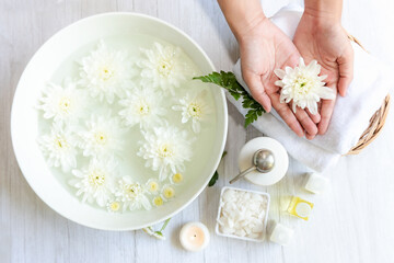 Fototapeta na wymiar Spa beauty massage health wellness. Spa Thai therapy treatment aromatherapy for nail and hands woman with white flower nature candle for relax and summer time.  Lifestyle and cosmetic Concept