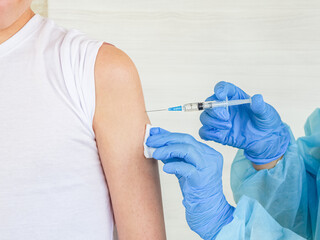 
A nurse vaccinates a person for vaccination against coronavirus infection. Coveid-19 pandemic...