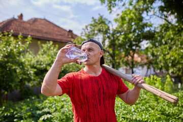Man farmer drinking water