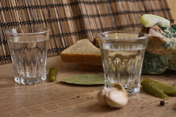 two glasses of vodka and an appetizer