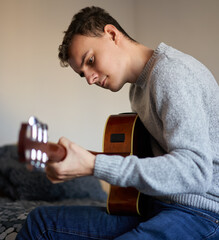 Teenage boy playing guitar