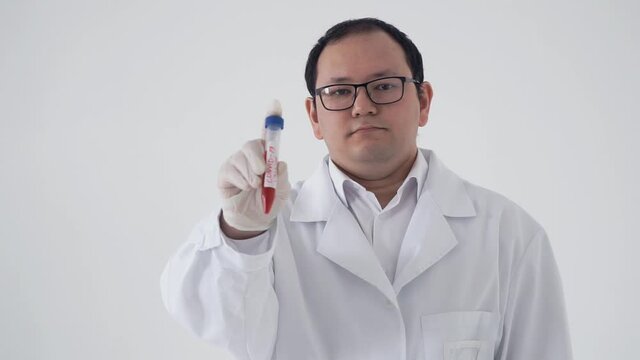 A scientist has developed a coronavirus vaccine in a laboratory. A man in a white coat shows a test tube with an antiviral substance