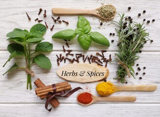 Herbs and spices rich in antioxidant. Various herbs and spices as natural sources of health. Dried spice and fresh herb selection. Cinnamon clove peppercorn turmeric mint rosemary basil chili powder.