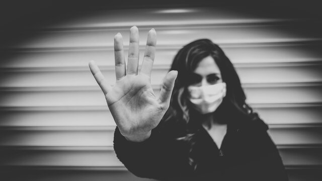 Young woman wearing medical mask to protect coronavirus on the street - Powered by Adobe