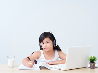 Little girl doing online class.