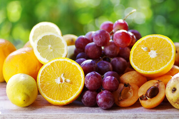 Fototapeta na wymiar citric fruit , loquat and grapes on table