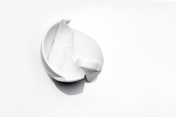 broken white ceramic tea cup on a white background top view, conceptual photo with a shattered...