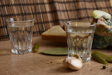 two glasses of vodka and an appetizer