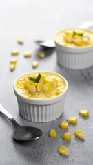 Homemade sweet corn custard dessert in ramekin over light background