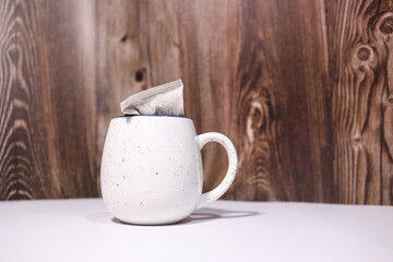 a cup and a coffee tea bag