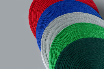 rolls of textile tape on gray background. color tape production.
