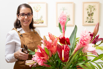 Woman making a flower arrangement at home