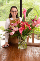Woman making a flower arrangement at home