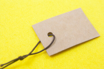 empty paper tag over yellow background