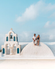 Obraz premium A couple, a bride and groom at Santorini Greece before their wedding.