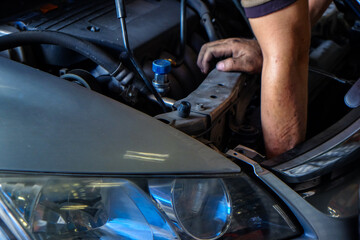Car servicing man hand replacing of tube cool air