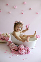A little girl is having fun bathing. The concept of children's bathing without tears. Baby shampoo that doesn't sting your eyes.