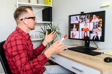 Online meeting, conference call. Young confident man is using PC software for video communication...