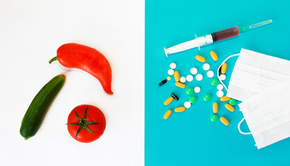 medicine tablets, syringe, medical masks and vegetables, red tomato, pepper and a cucumber