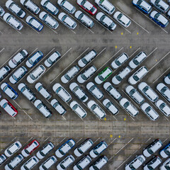 New car lined up aerial view. Port of import and export business logistic to dealership for sale....
