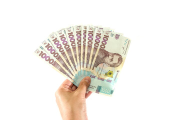 new 1000 hryvnia in hand isolated on white background. A lot of hryvnia.