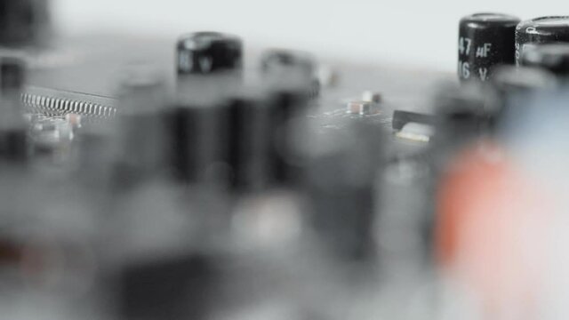 Printed circuit board hardware device with electrical components, electrolytic capacitors, resistors, transistors, integrated microchips, chips. Macro of sound audio internal expansion card, smt