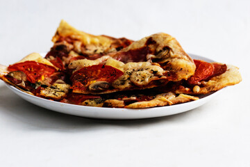 Homemade pizza on a white plate. Candid.