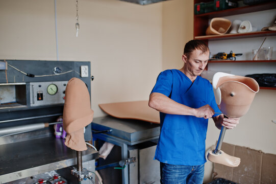 Prosthetist man making prosthetic leg while working in laboratory.
