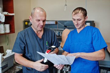 Two prosthetist man workers making prosthetic leg while working in laboratory.