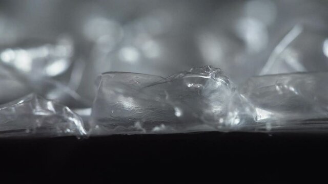 Finger compresses, ruptures bubble on air wrap film plastic packaging material, macro. Nervous system concept. Type of tactile amusement playing. Calming effect with enjoy. Give pleasure. Satisfaction
