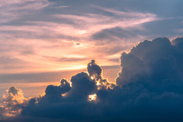 Dramatic sky at sunset. Sunlight shines behind the clouds