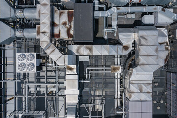 Fototapeta premium Air Condition Ventilation System on the Building Roof. Industrial Air system of ventilation and Air conditioning. Aerial Shot.