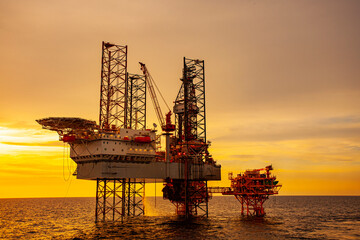 oil drilling rig at sunset