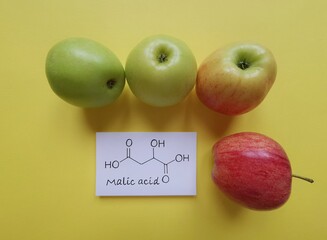Structural chemical formula of malic acid molecule. Malic acid is the main acid in many fruits,...
