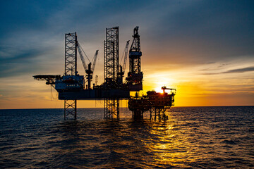 oil drilling rig at sunset