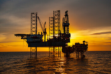 oil drilling rig at sunset