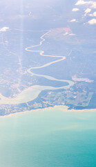 Aerial of the curvy river drain to the sea. Pastel tone applied
