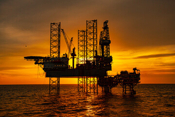 oil drilling rig at sunset