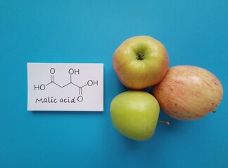 Structural chemical formula of malic acid molecule. Malic acid is the main acid in many fruits, including apples. Malic acid contributes to the sour taste of fruits and is used as a food additive.