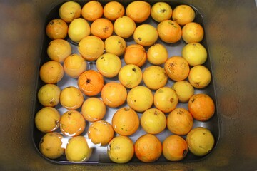 Fresh oranges under cool water