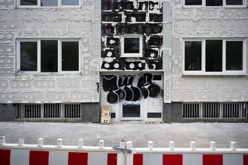 Adhesive residues of insulation panels on a house facade form a grid pattern. Red and white...