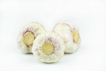 Three heads of garlic isolated on a white background.