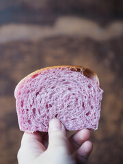 hand holding slice of purple sweet potato bread