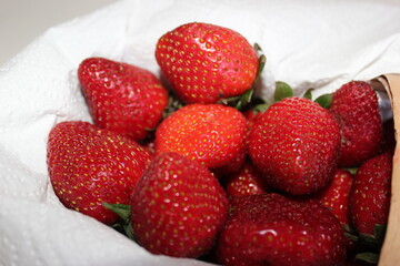 ripe strawberries in a basket on a white background