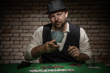 Poker player throwing cards at the table - poker in a dark back room with a brick wall