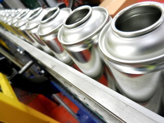 Empty aerosol cans awaiting filling in production factory