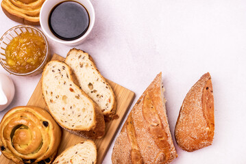 Tasty Breakfast Freshly Baked Buns with Raisins and Cinnamon Fresh Homemade Bread Cup of Black Coffee Orange Jam in Glass Bowl Top View Copy Space